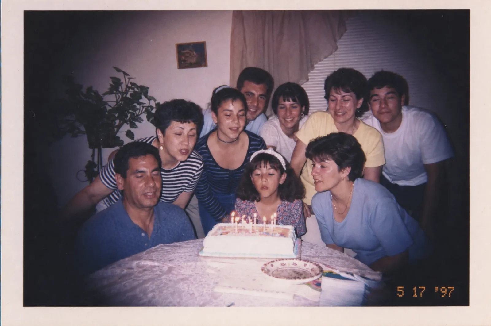 A 1997 birthday gathering shot on a disposable camera, generated from prompt 8: white print border, orange dot-matrix date stamp, heavy corner vignetting and a magenta lab cast